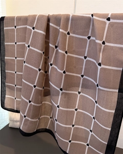 Detail of checkered pashmina with small black hearts and contrasting black border