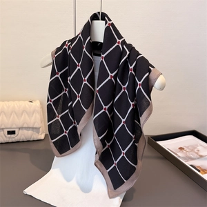 Detail of silk-feel scarf featuring black and white grid patterns with small red hearts