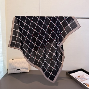 Classic black grid scarf with red hearts on a stand, showcasing soft silk-like texture