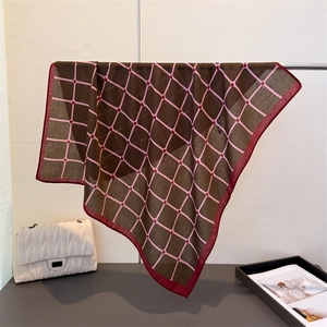 Detail of checkered silk scarf with heart pattern hanging on a metal display stand