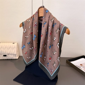 Plaid herringbone silk scarf with equestrian horse print hanging on wooden hanger
