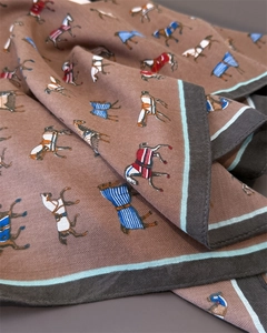 Detail of herringbone weave fabric featuring equestrian horse print on brown silk scarf
