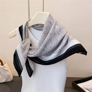 Detail of herringbone linen-feel square scarf with purple dotted print on light grey