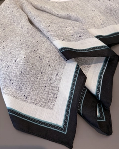 Detail of light grey cotton-linen square scarf with purple texture and geometric border