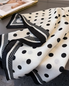 Detailed view of polka dot herringbone scarf showing fine fabric texture and contrast border