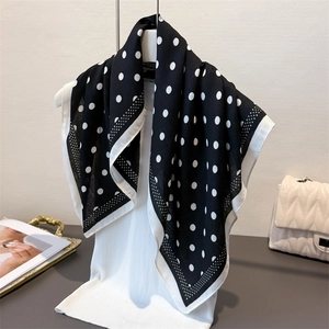 Detail view of polka dot pattern scarf with elegant white borders and soft texture