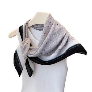 Elegant herringbone texture cotton linen scarf with gray spots and blue trim on mannequin