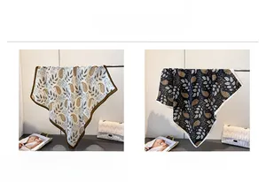 Detail view of cotton-linen feel scarves with vintage paisley prints in white and black