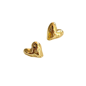 3D gold heart stud earrings with vintage embossed textures on a clean white background