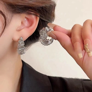 Modern irregular silver spiral hoop earrings with layered industrial aesthetic design
