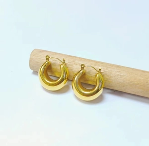 Macro shot of 18K gold plated chunky hoop earrings with a high-polished mirror finish