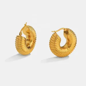 Détail des boucles d'oreilles créoles plaquées or 18K avec texture spirale creuse