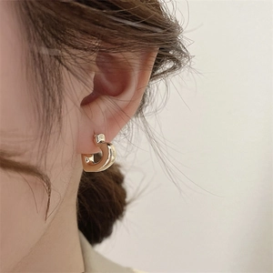 Polished chunky gold-plated C-shaped hoop earrings for women shown on a model