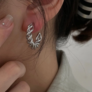 Modern silver-toned twisted hoop earrings with a minimalist spiral metal texture for women