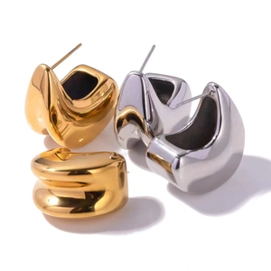 Polished gold and silver irregular geometric C-shaped hoop earrings in minimalist style
