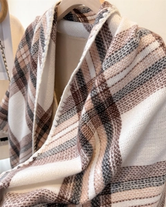 Detail of classic plaid pattern scarf with soft fringe edges and thick cashmere texture