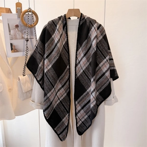 Close-up of black and white plaid knit shawl with detailed stitching and soft texture