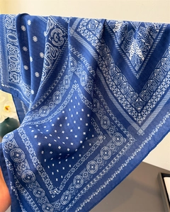 Detailed macro view of dark blue paisley pattern on lightweight cotton-linen scarf fabric