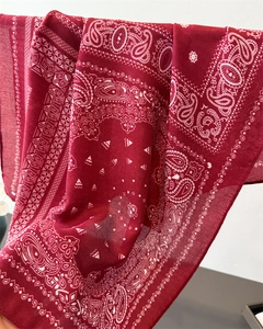 Detailed macro view of red paisley cotton-linen scarf with vintage ethnic patterns