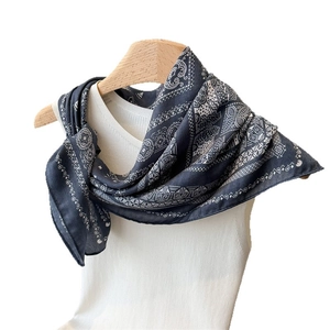 Classic dark navy paisley patterned lightweight scarf draped on a simple hanger
