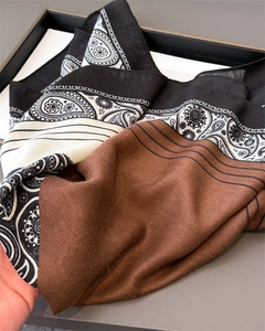 Macro detail of herringbone and paisley print cotton-linen scarf with premium texture