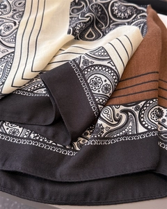 Macro detail of paisley print scarf featuring herringbone texture and color blocking