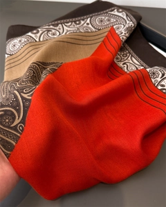 Detail of red herringbone weave and vintage paisley pattern on a soft pashmina scarf