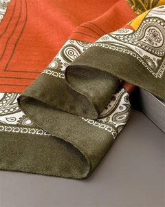 Detail of herringbone weave texture and colorful paisley pattern on cotton-linen scarf