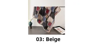 Close-up of beige paisley silk scarf with geometric patterns hanging on a rack