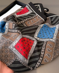 Close-up of paisley and geometric pattern patchwork on silky soft square neck scarf