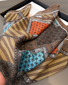 Detail of bohemian paisley print silk scarf with satin luster and geometric patterns