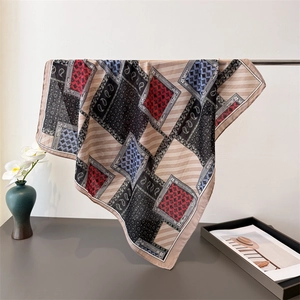 Close-up of lightweight paisley and geometric pattern scarf draped over a vase