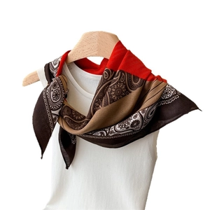 Ethnic paisley pattern silk-feel square scarf styled on white vest with wooden hanger