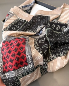 Close-up of paisley and geometric pattern silk scarf with elegant draped texture