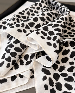 Detail of black and white leopard print scarf showing fine twill texture and soft folds
