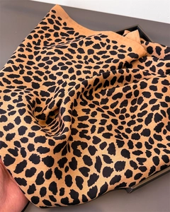 Detailed view of leopard print cotton-linen scarf showing soft woven texture and pattern