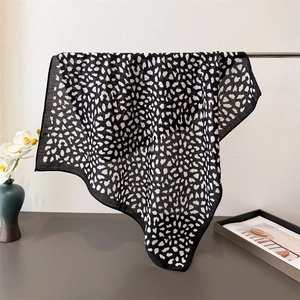 Detail of lightweight leopard print scarf showing soft texture and fine edge stitching