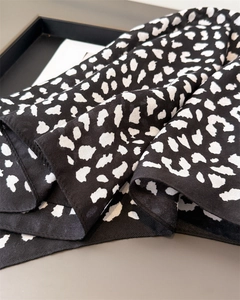 Detailed view of lightweight leopard print scarf with smooth texture and neat hem stitching