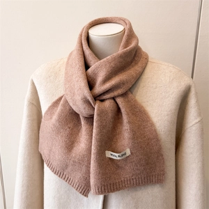 Detailed texture of dusty pink wool blend knitted scarf with ribbed edges for autumn