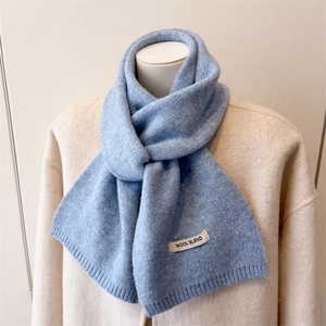 Minimalist light blue wool blend knitted scarf with premium brand label for winter warmth