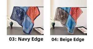 Detail view of paisley square scarves in navy and beige colors on an elegant display