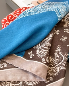 Macro detail of silk-like paisley bandanas showing twill weave and rolled edges