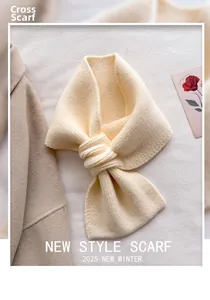 Close-up of cream knit cross scarf with dense stitching on a minimalist background