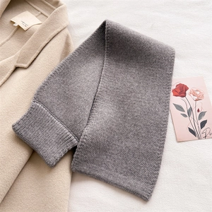 Detail of grey knitted scarf with thick weave texture and classic ribbed edge design