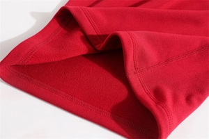 Detailed close-up of thermal fleece lining on a thick red winter neck warmer