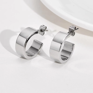 Minimalist wide C-shape stud earrings in polished silver finish on white background