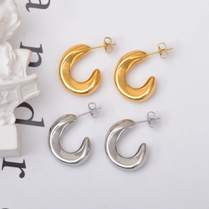 Polished gold and silver C-shaped hoop earrings with minimalist high-gloss finish
