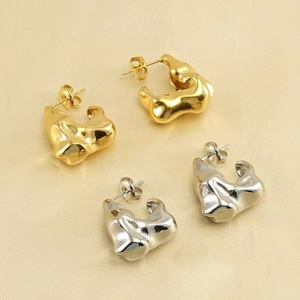 Minimalist irregular lava earrings in gold and silver finish with polished metal texture