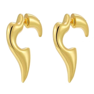 Detailed close-up of shiny gold-plated curved flame earrings with a polished artistic finish