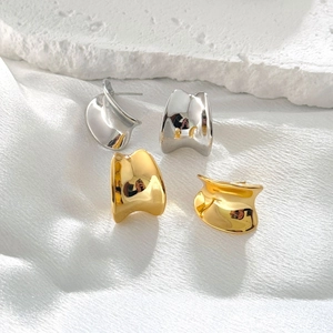 Minimalist geometric polished metal stud earrings in gold and silver finish